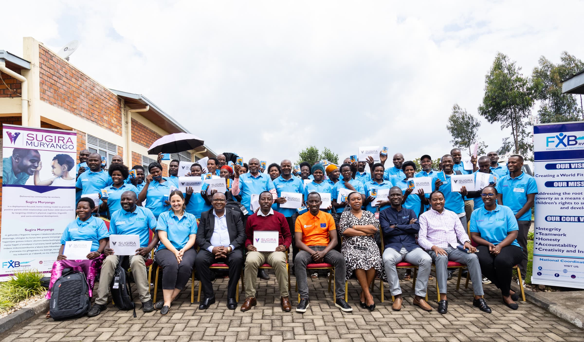 Participants and staff in Sugira Muryango shirts at a community gathering
