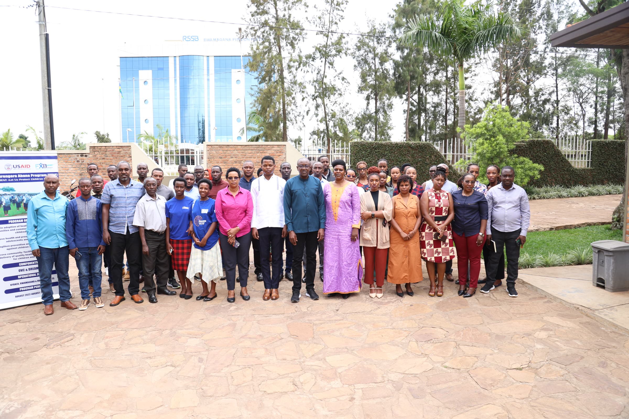 Participants and staff standing together at the closing of an FXB Rwanda project in Rwamagana